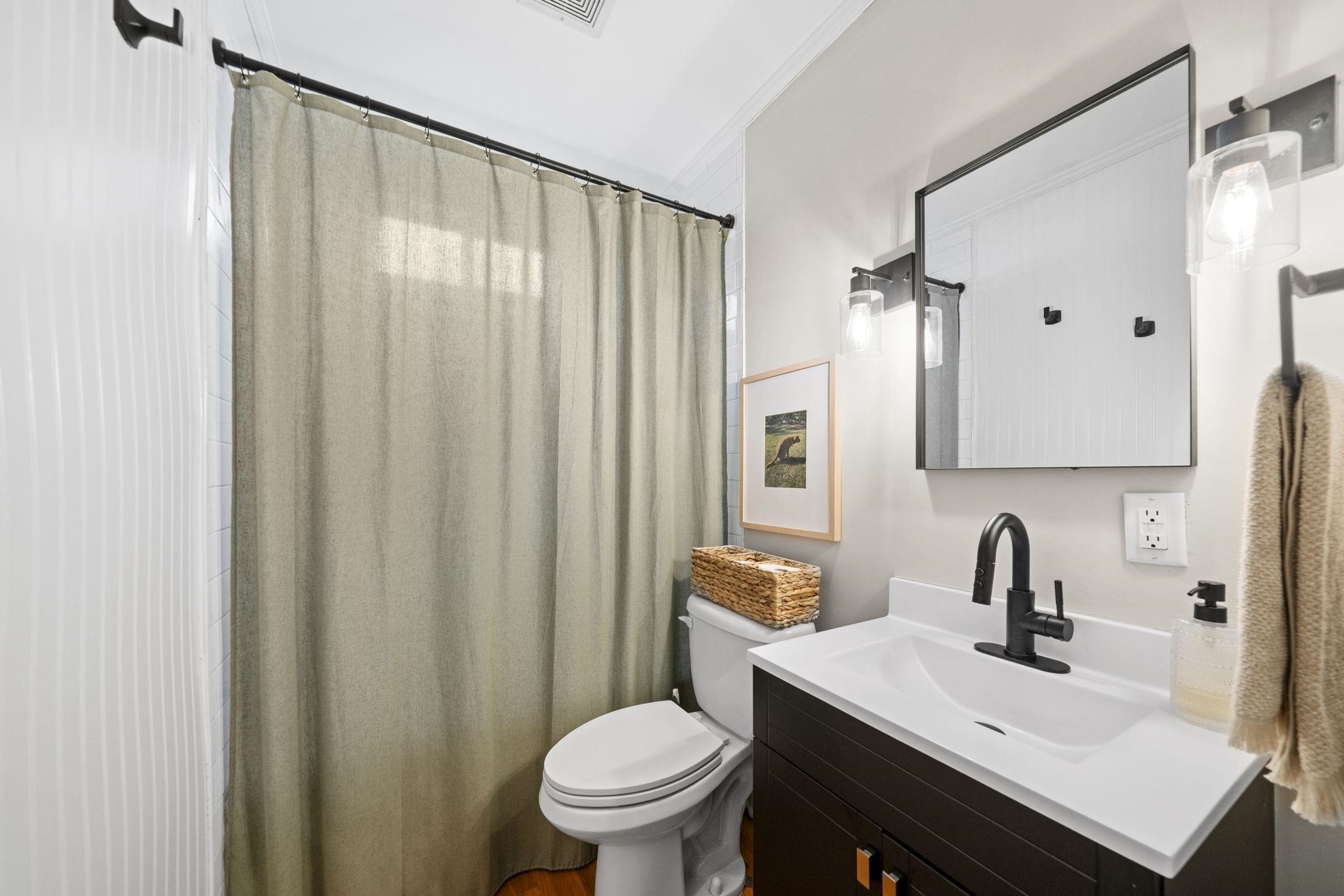 311 South 3rd Street Oregon, IL 61061 - Photo 13 of 24 a bathroom with a sink a toilet and a mirror