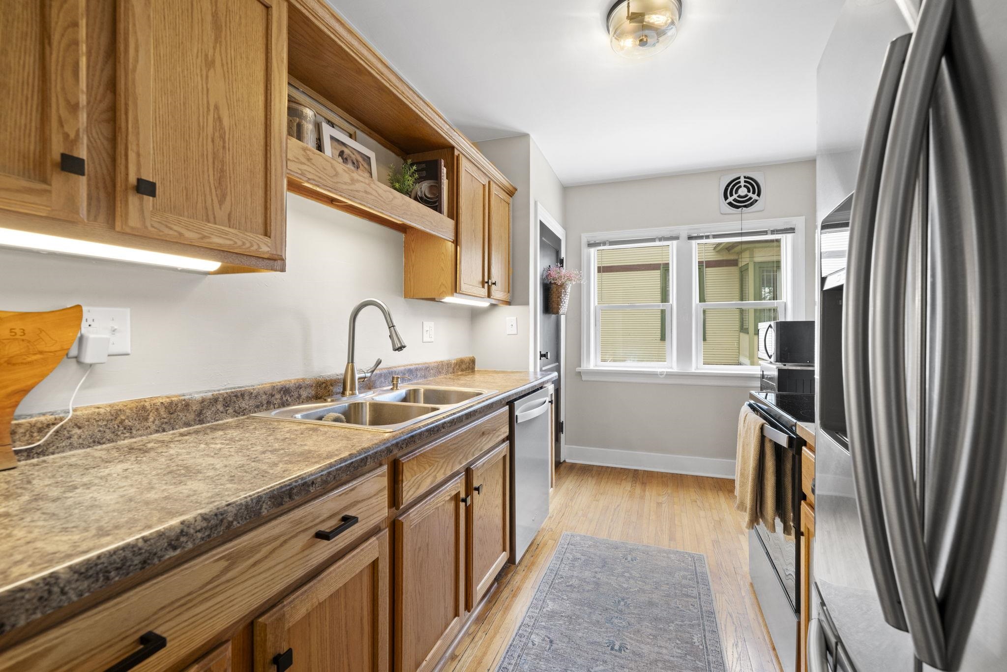 311 South 3rd Street Oregon, IL 61061 - Photo 8 of 24 a kitchen with stainless steel appliances granite countertop a sink stove and cabinets