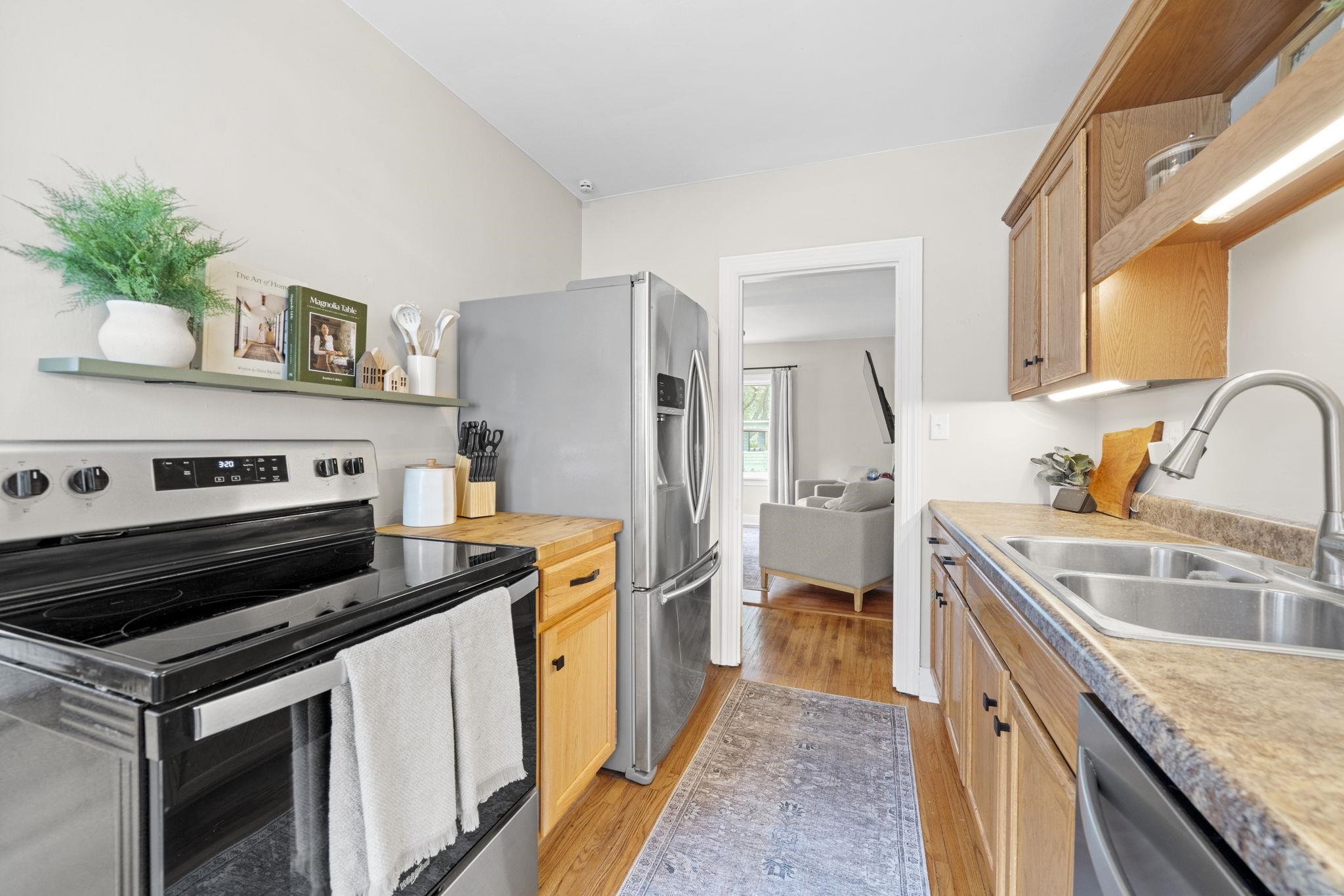 311 South 3rd Street Oregon, IL 61061 - Photo 9 of 24 a kitchen with a stove microwave and refrigerator