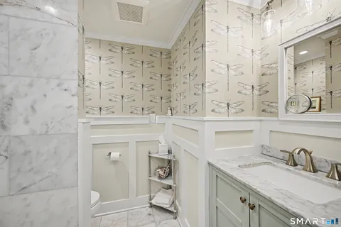 a bathroom with a sink vanity granite tub and shower