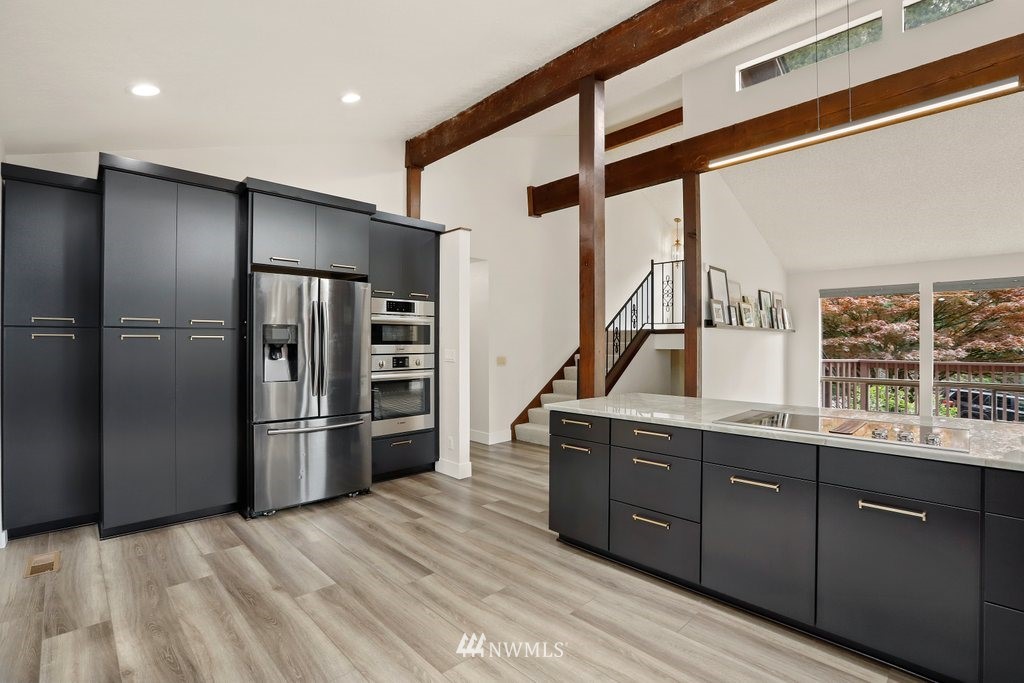 20830 28th Avenue Southeast Bothell, WA 98021 - Photo 13 of 40 a kitchen with stainless steel appliances granite countertop a refrigerator and a sink