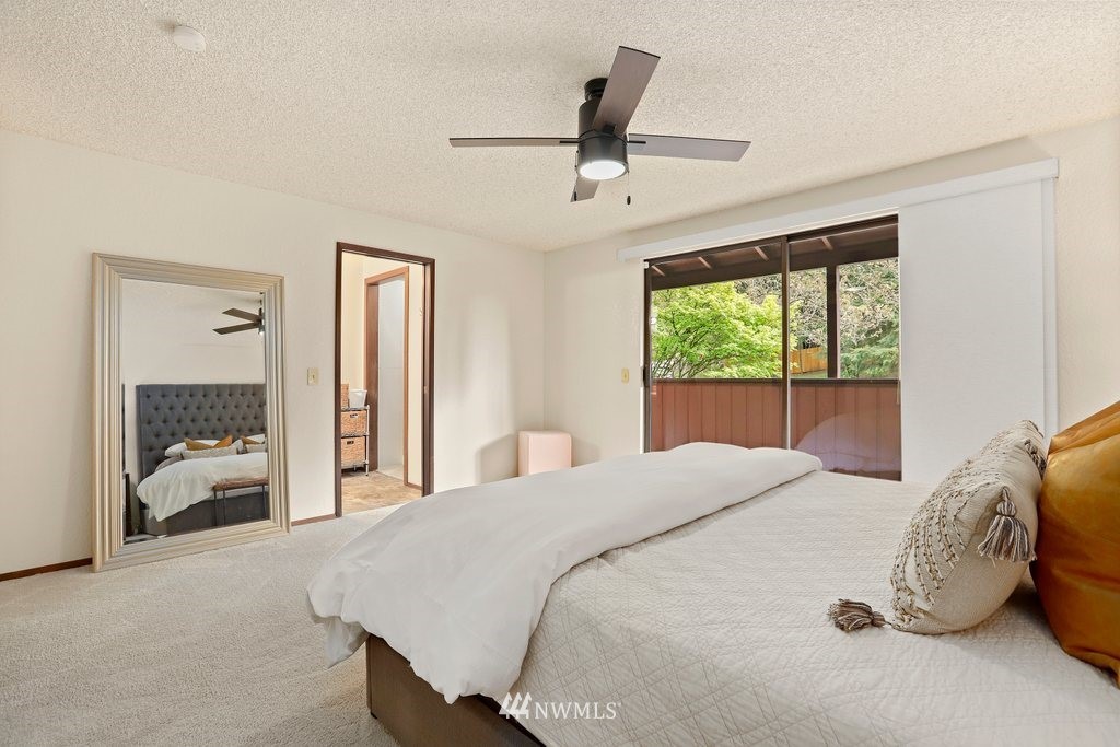 20830 28th Avenue Southeast Bothell, WA 98021 - Photo 18 of 40 a bedroom with a large bed and a large window