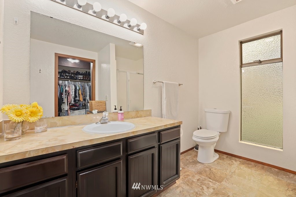 20830 28th Avenue Southeast Bothell, WA 98021 - Photo 20 of 40 a bathroom with a granite countertop sink mirror vanity and toilet
