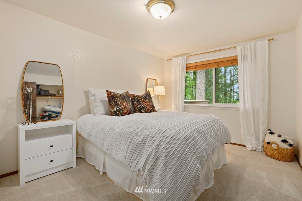 20830 28th Avenue Southeast Bothell, WA 98021 - Photo 22 of 40 a bedroom with a bed and a mirror