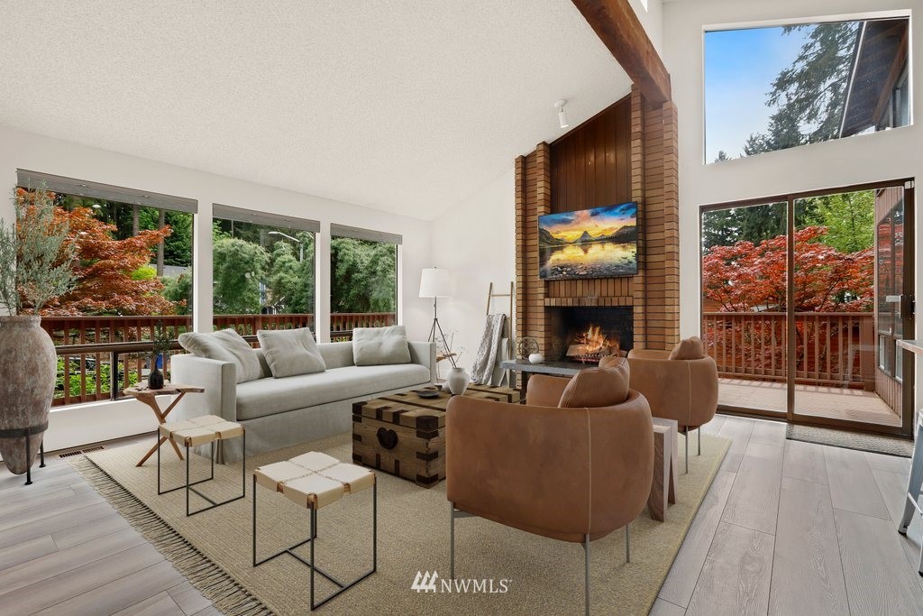 20830 28th Avenue Southeast Bothell, WA 98021 - Photo 3 of 40 a living room with furniture a fireplace and a floor to ceiling window