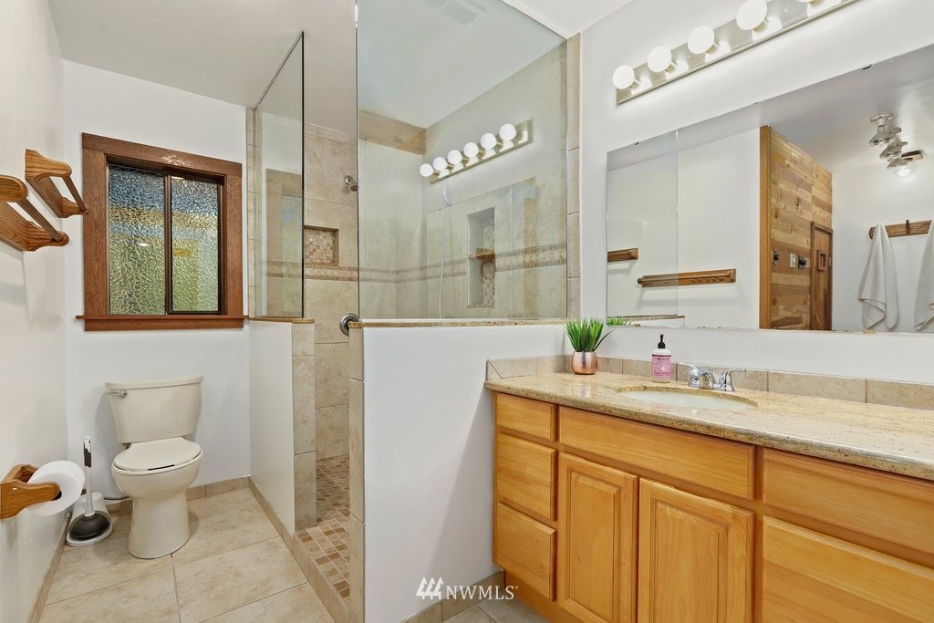 20830 28th Avenue Southeast Bothell, WA 98021 - Photo 31 of 40 a bathroom with a toilet sink and mirror