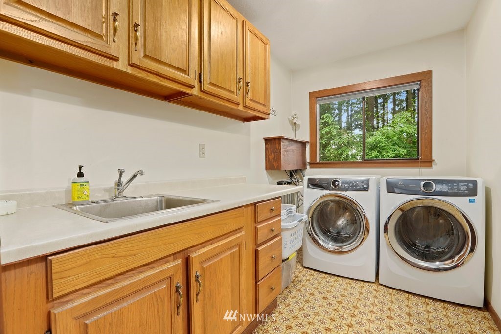 20830 28th Avenue Southeast Bothell, WA 98021 - Photo 33 of 40 a utility room with sink dryer and washer