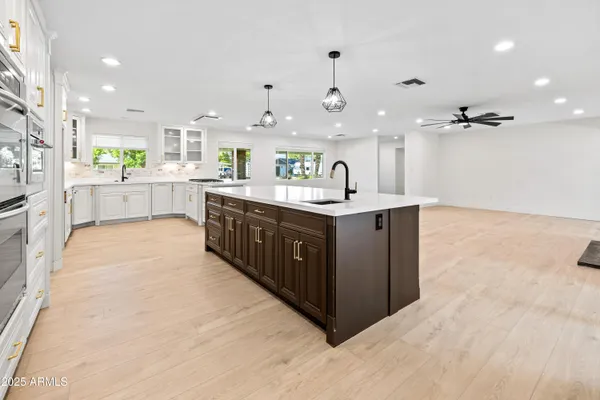 a kitchen with stainless steel appliances granite countertop a sink and a refrigerator