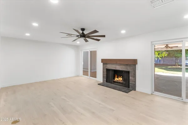 a view of livingroom with furniture fireplace and window