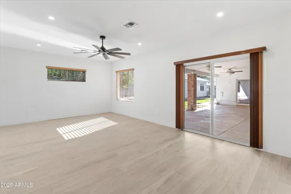 a view of a livingroom with a ceiling fan and window