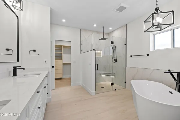 a white bath tub with a close up of a sink