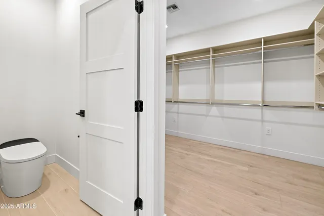 a bathroom with a sink toilet vanity and shower