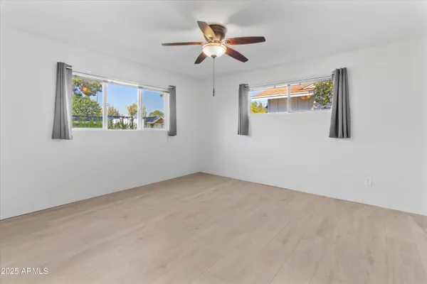 wooden floor in an empty room with a window