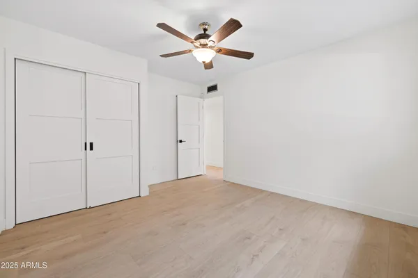 a view of walk in closet with empty racks