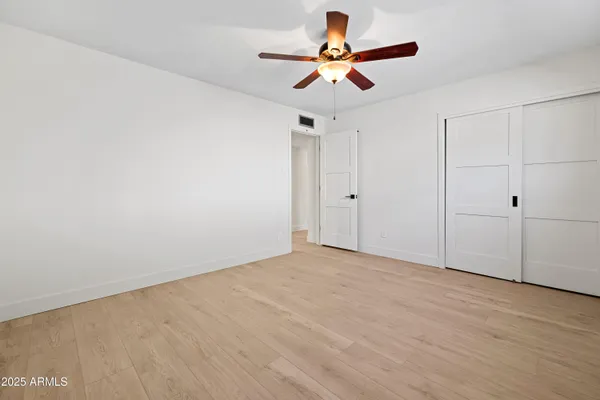 a view of a livingroom with furniture and a ceiling fan