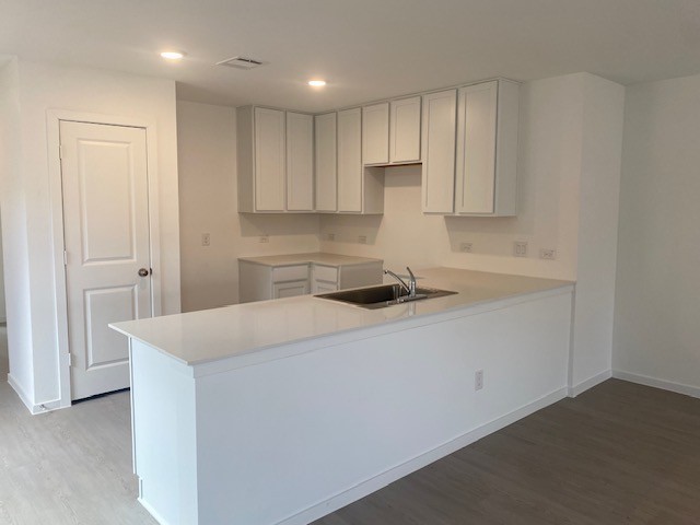 3045 Colusa Rdg Drive Katy, TX 77493 - Photo 11 of 26 a kitchen with a sink a stove and cabinets