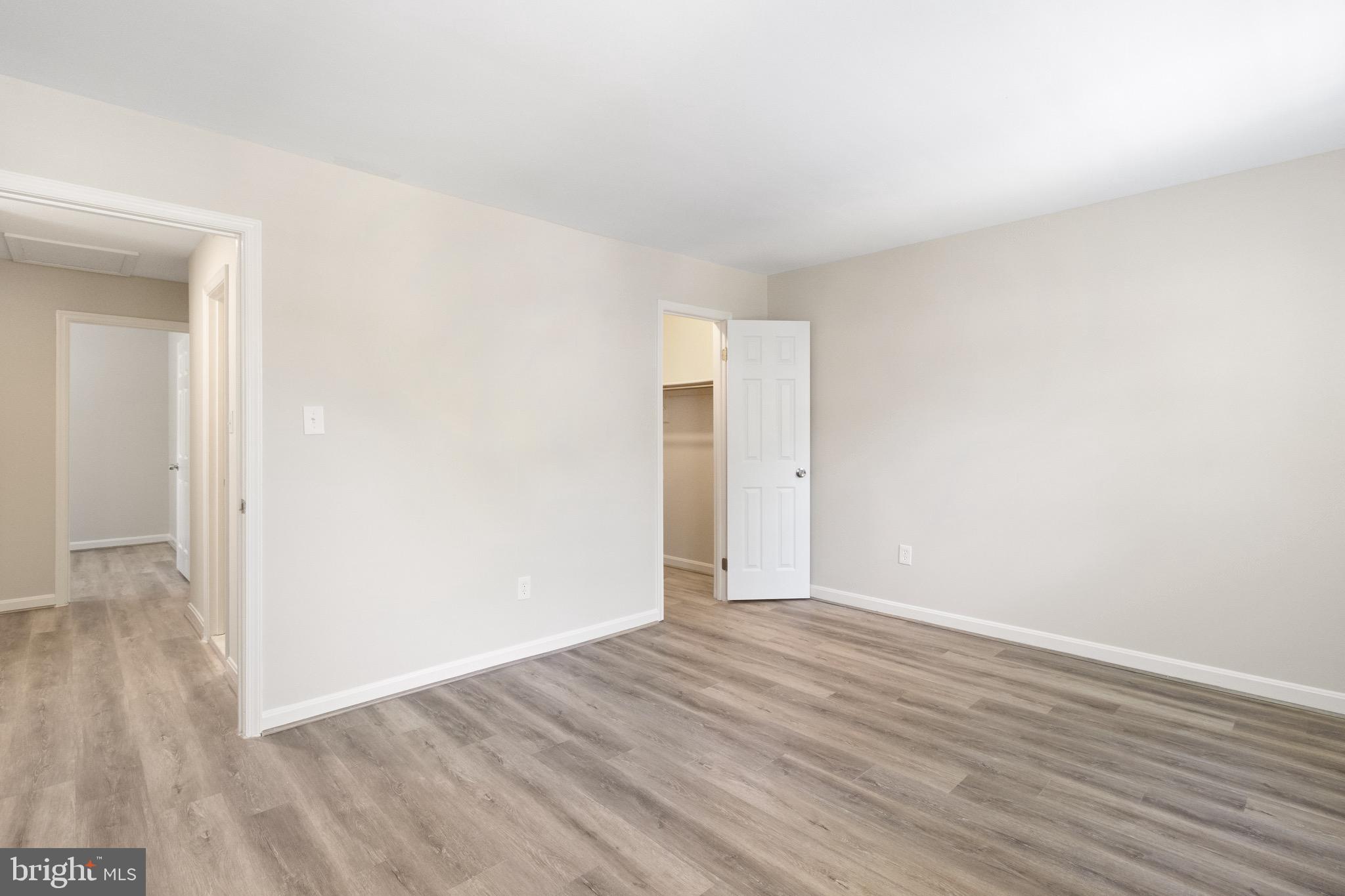 8581 Chester Grove Court Springfield, VA 22153 - Photo 23 of 38 a view of an empty room with wooden floor