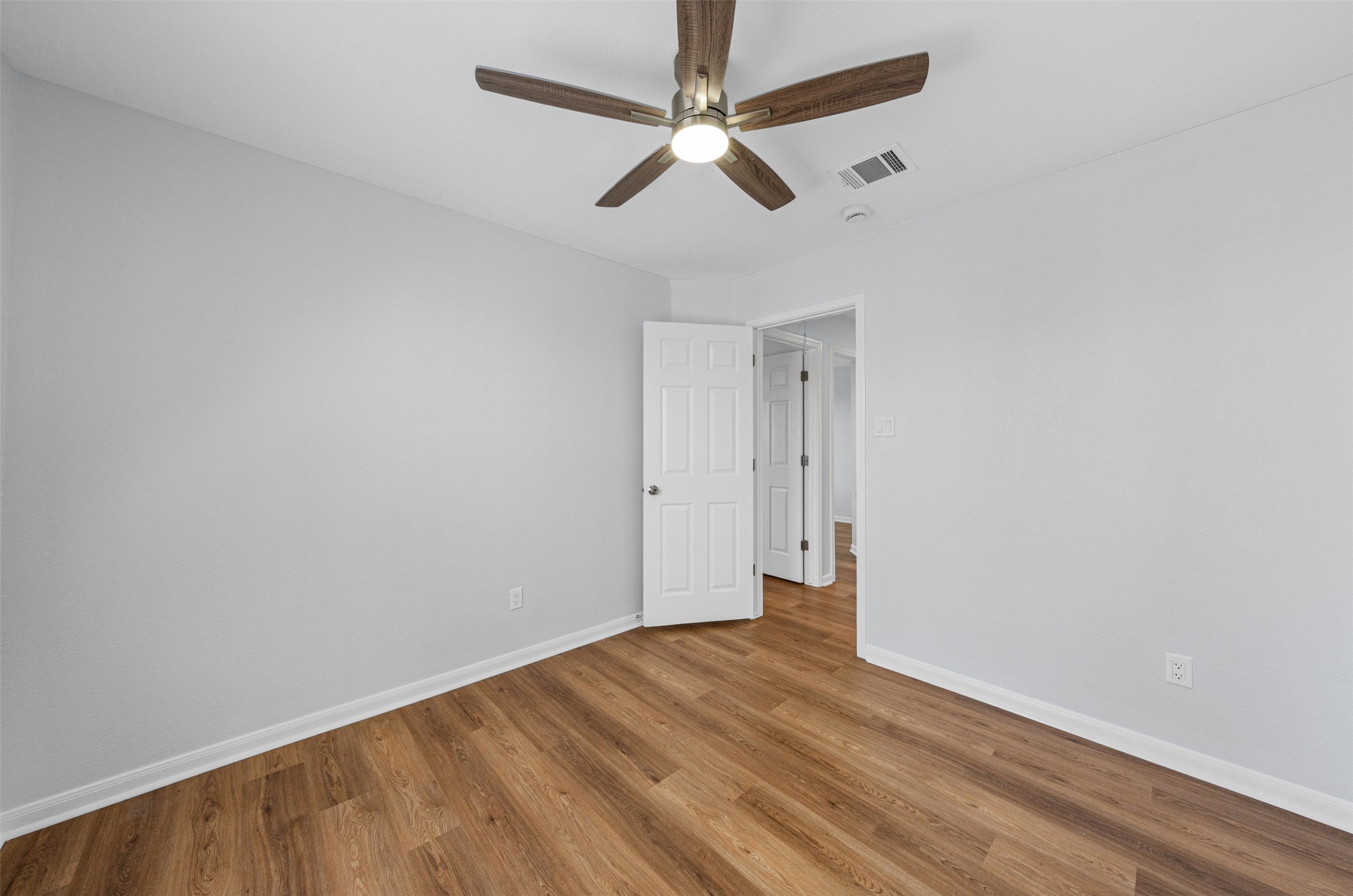 243 Engineers Pass Jarrell, TX 76537 - Photo 19 of 40 Interior space featuring wood-finish flooring, white baseboards, and light gray walls