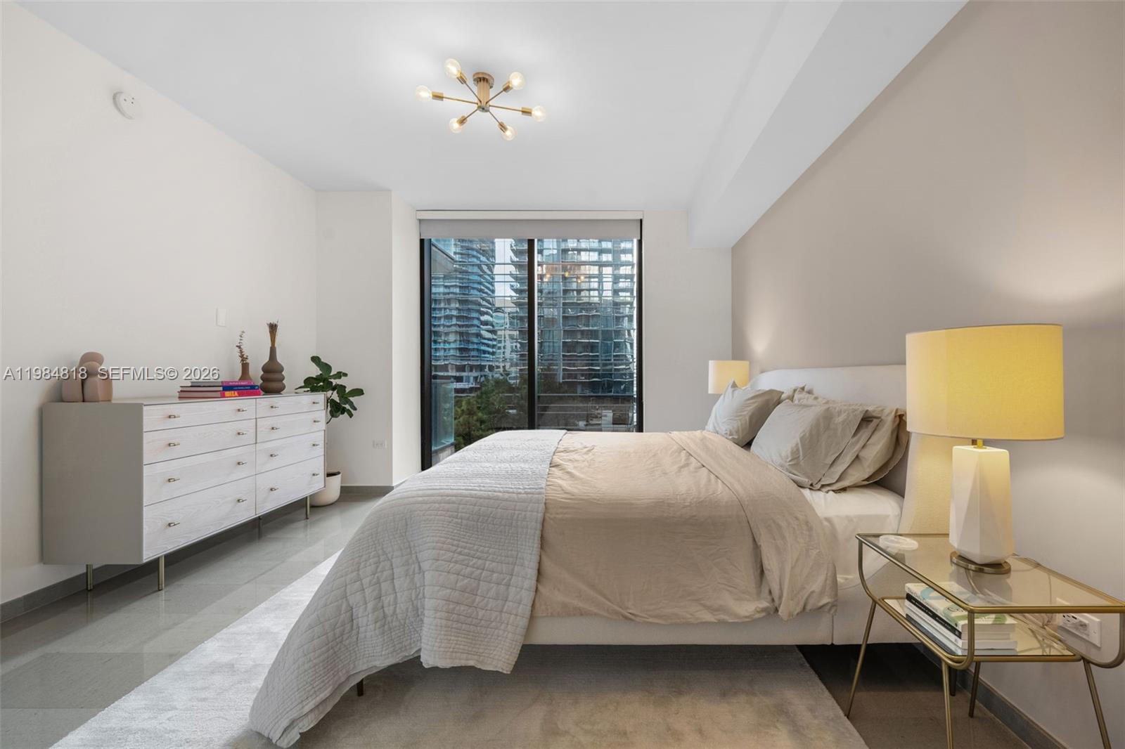 88 Southwest 7th Street, Unit 809 Miami, FL 33130 - Photo 11 of 39 a bedroom with a bed and a window