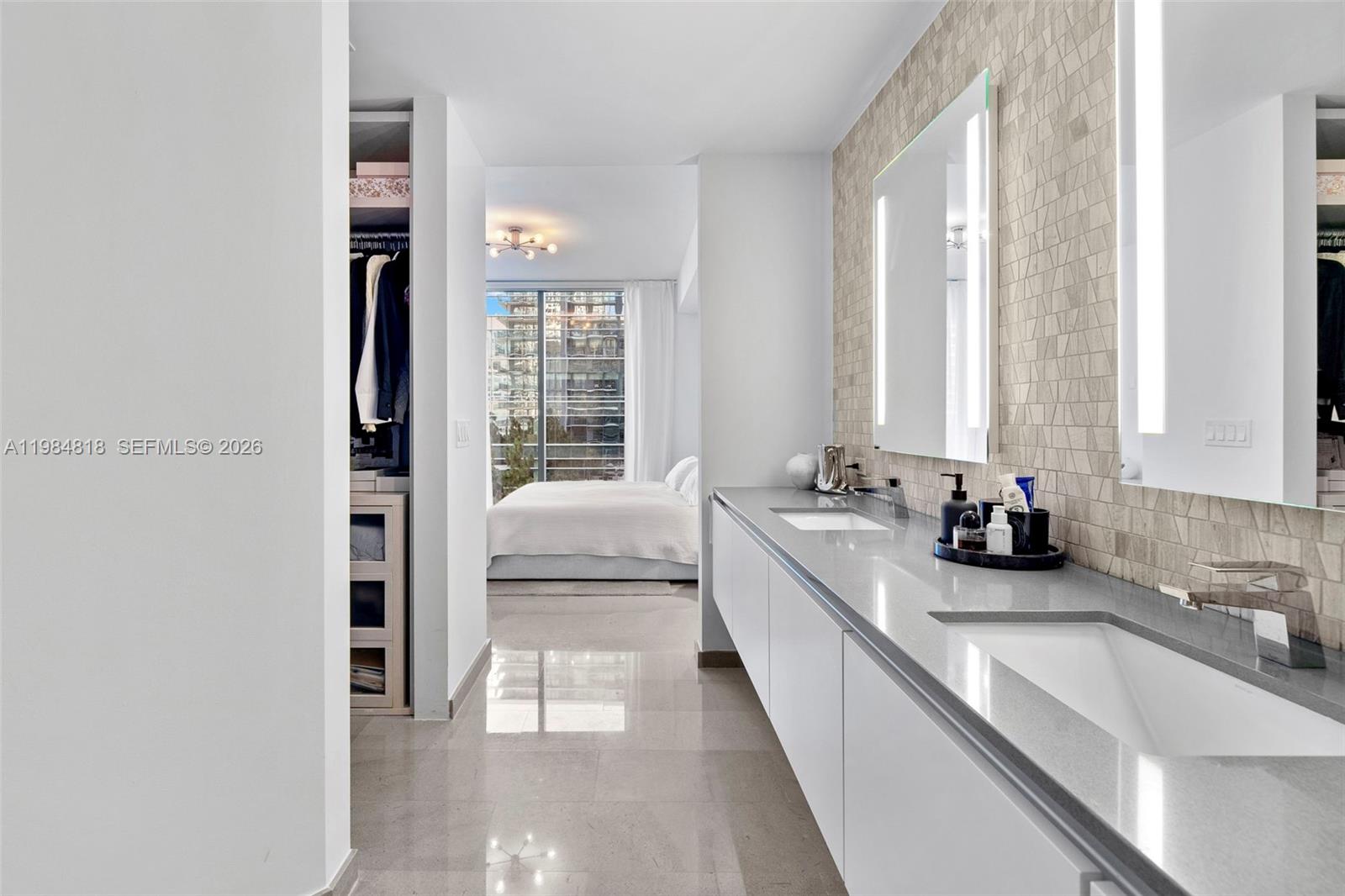 88 Southwest 7th Street, Unit 809 Miami, FL 33130 - Photo 13 of 39 a bathroom with a double vanity sink and a bathtub