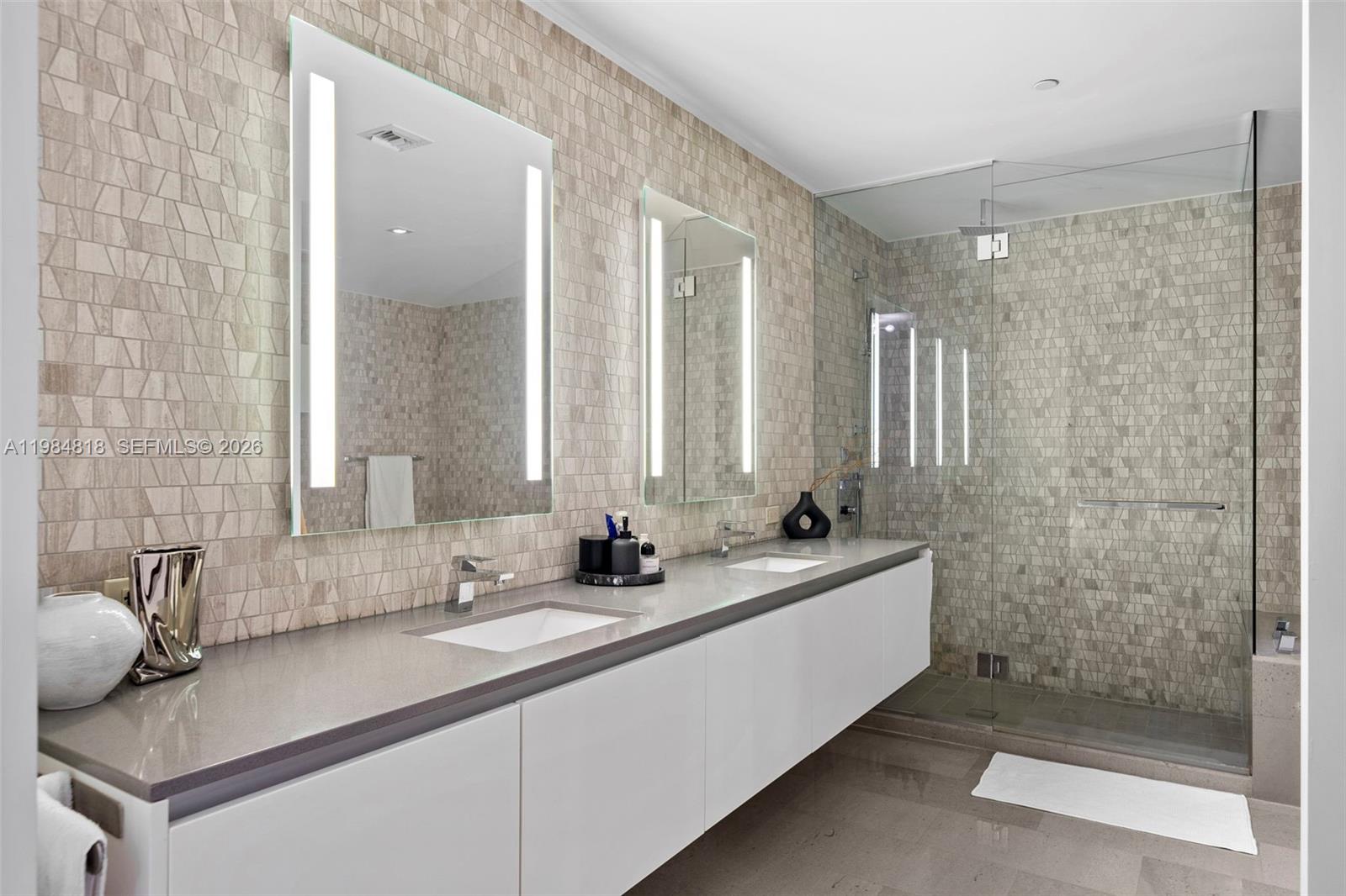 88 Southwest 7th Street, Unit 809 Miami, FL 33130 - Photo 14 of 39 a bathroom with a double vanity sink mirror and shower