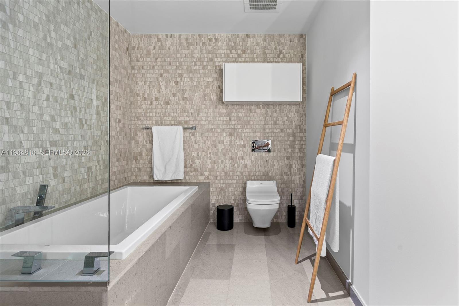 88 Southwest 7th Street, Unit 809 Miami, FL 33130 - Photo 15 of 39 a bathroom with a toilet and a bath tub