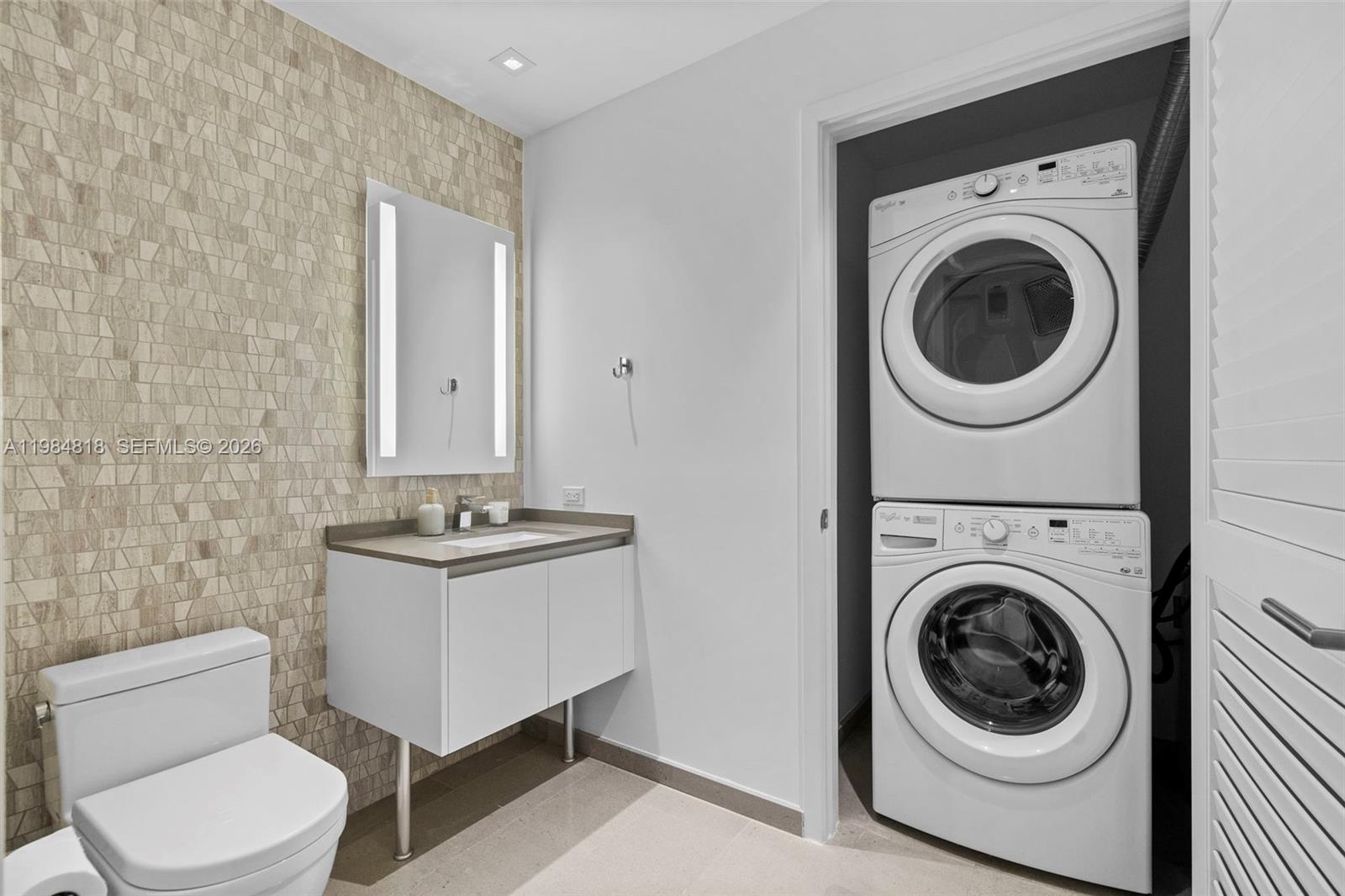 88 Southwest 7th Street, Unit 809 Miami, FL 33130 - Photo 18 of 39 a bathroom with a toilet mirror and sink