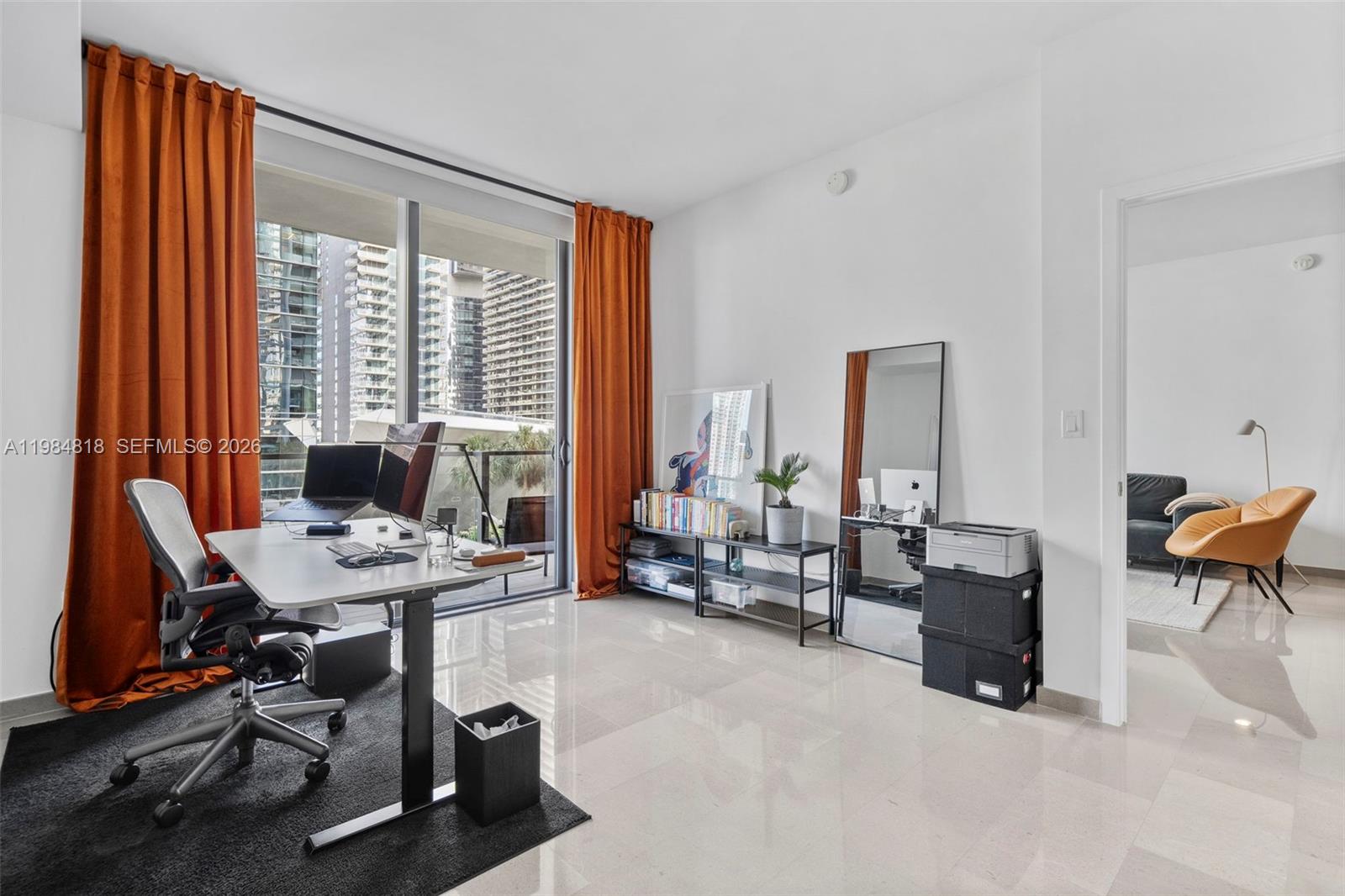 88 Southwest 7th Street, Unit 809 Miami, FL 33130 - Photo 20 of 39 a view of a livingroom with workspace and a window