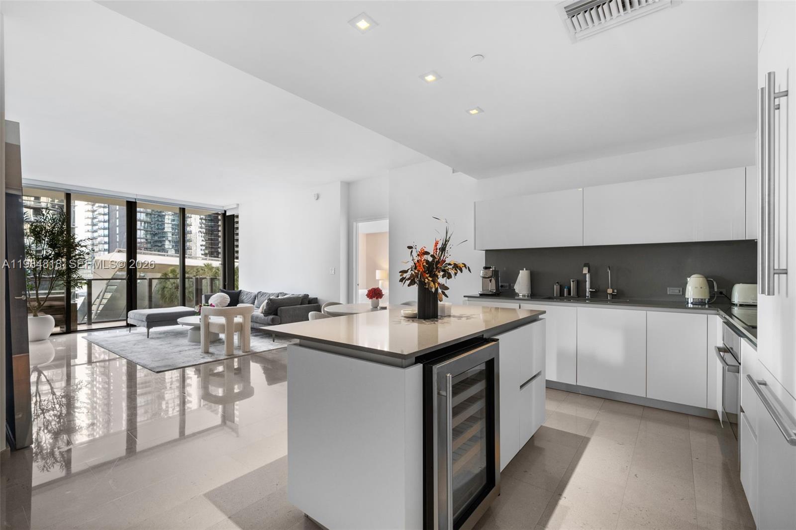 88 Southwest 7th Street, Unit 809 Miami, FL 33130 - Photo 2 of 39 a kitchen with a sink stove and cabinets