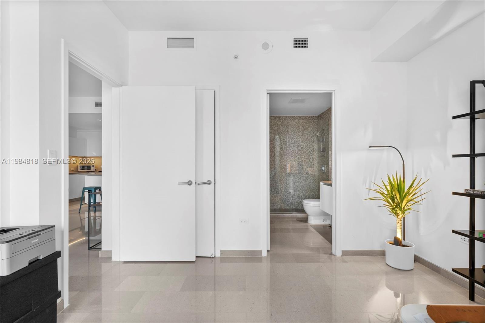 88 Southwest 7th Street, Unit 809 Miami, FL 33130 - Photo 22 of 39 a view of an entryway with wooden floor and a potted plant