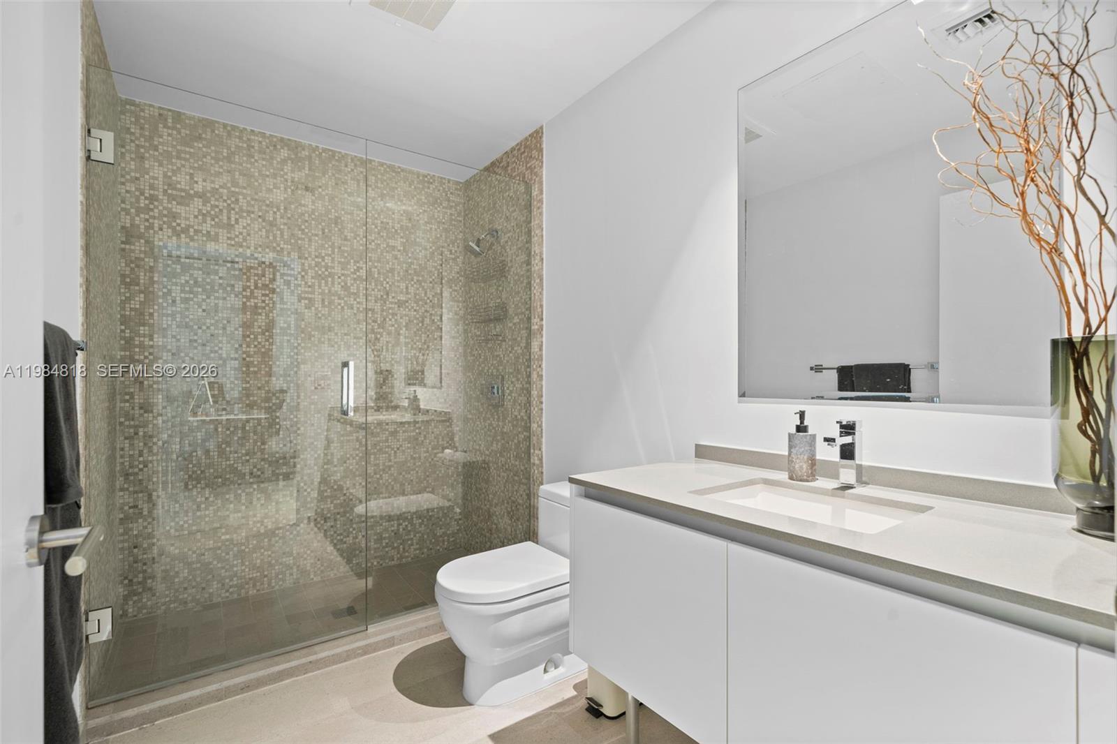 88 Southwest 7th Street, Unit 809 Miami, FL 33130 - Photo 24 of 39 a bathroom with a sink a toilet and shower