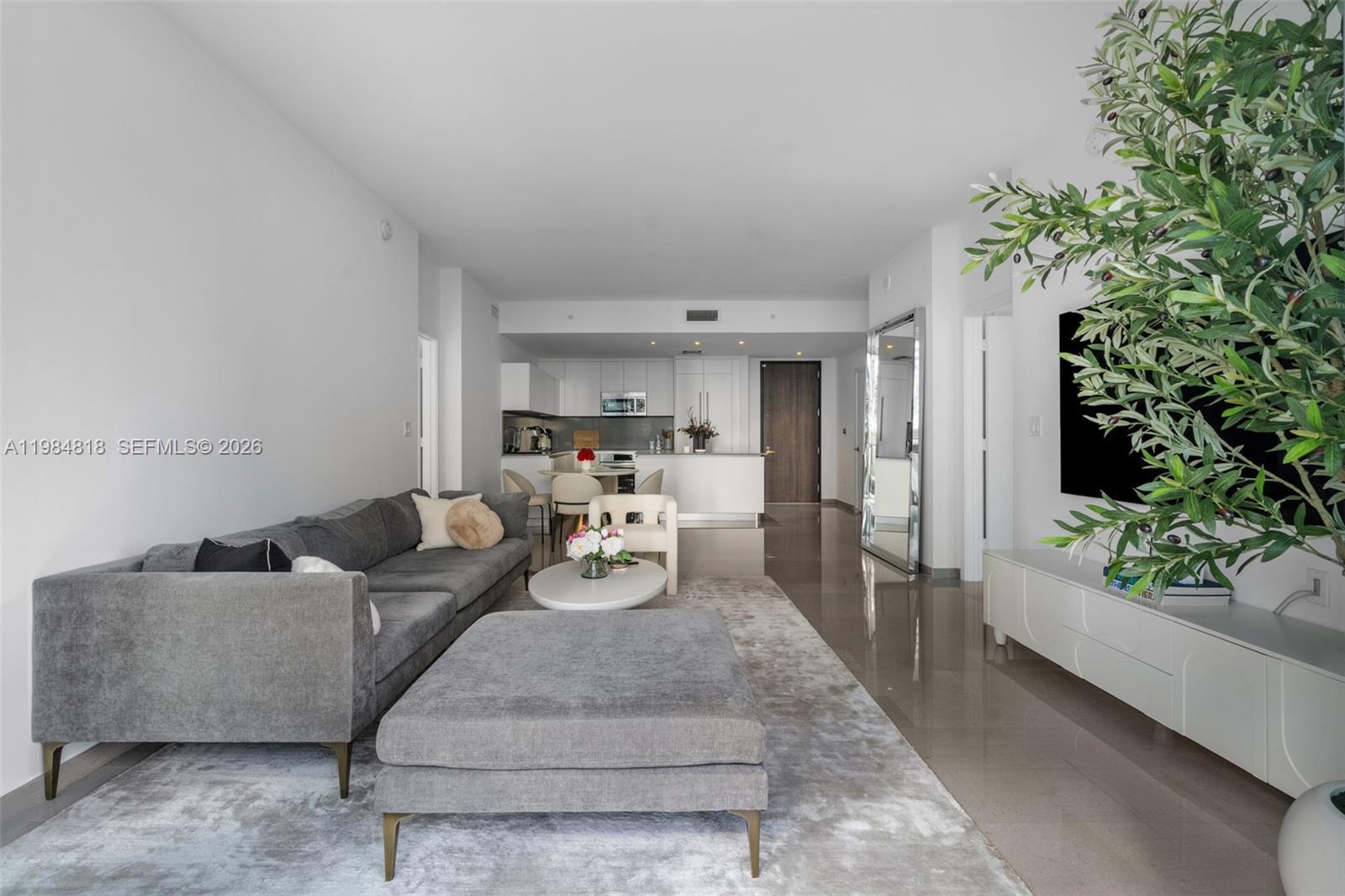 88 Southwest 7th Street, Unit 809 Miami, FL 33130 - Photo 8 of 39 a living room with furniture and a potted plant