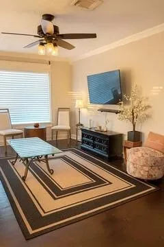 a living room with stainless steel appliances furniture and a rug