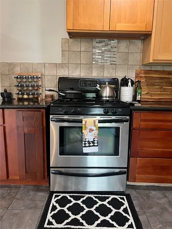 a stove top oven sitting inside of a kitchen