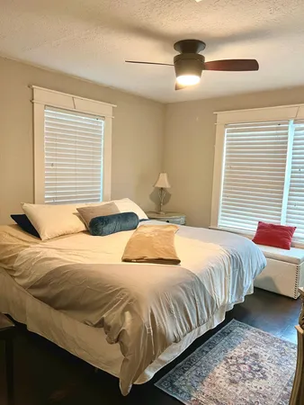 a bedroom with a bed and a window