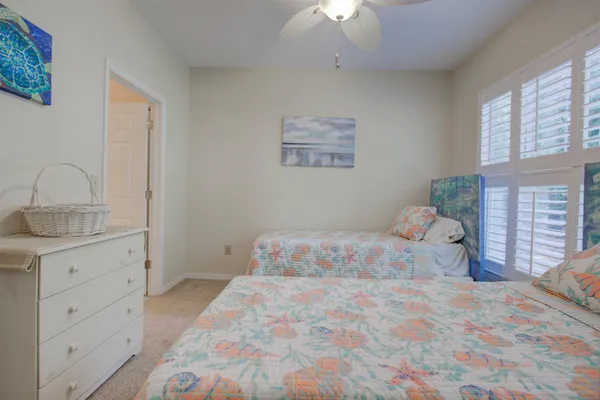 a large bed sitting in a bedroom next to a window