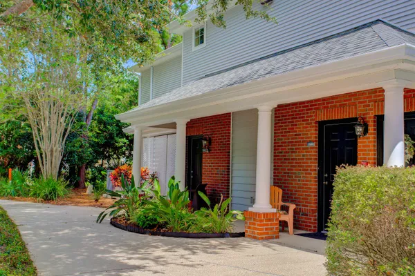 a bedroom with two beds and a chandelier