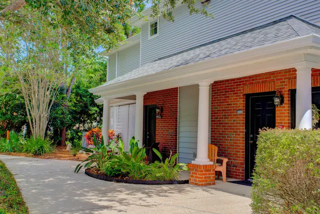 a bedroom with two beds and a chandelier