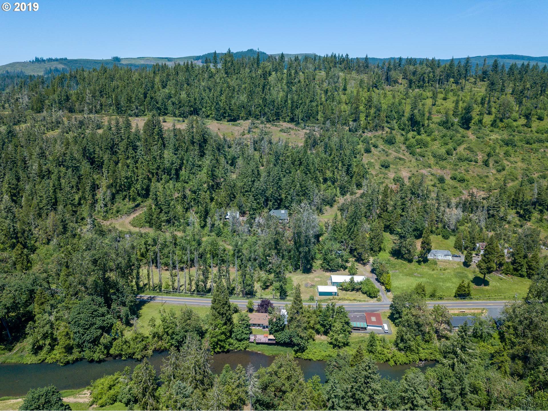 39639 Jasper Lowell Road Lowell, OR 97452 - Photo 26 of 32 a view of a lush green forest with trees and some houses