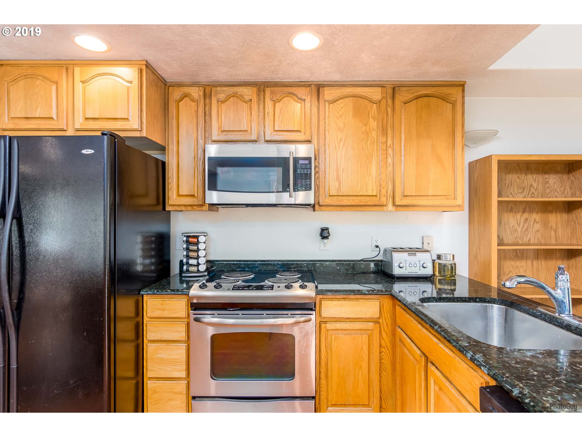 39639 Jasper Lowell Road Lowell, OR 97452 - Photo 5 of 32 a kitchen with stainless steel appliances granite countertop a sink stove and microwave