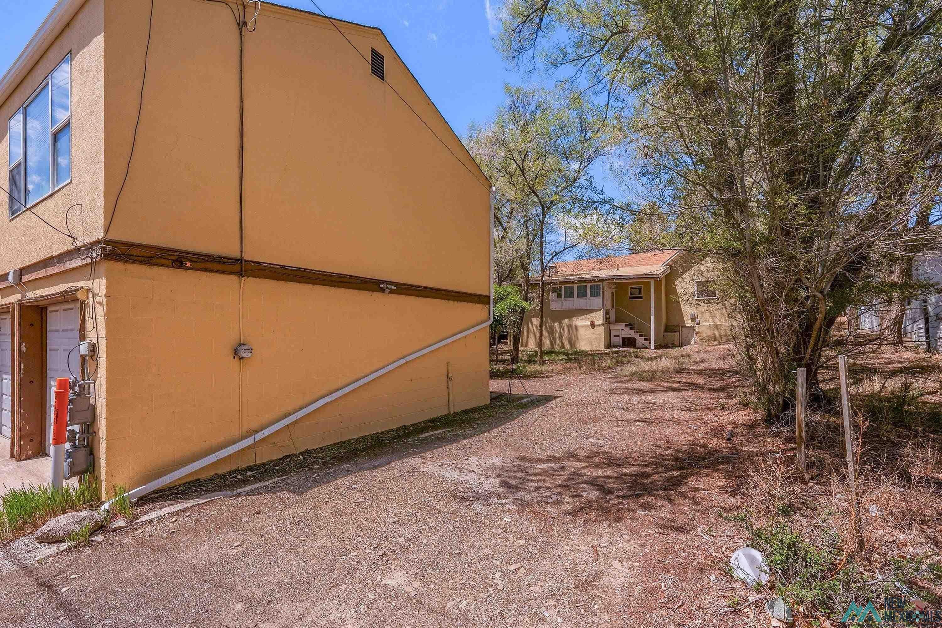 533 South 2nd Street Raton, NM 87740 - Photo 37 of 43 Property exterior featuring a multi-level structure with a stucco finish and an upper-level window