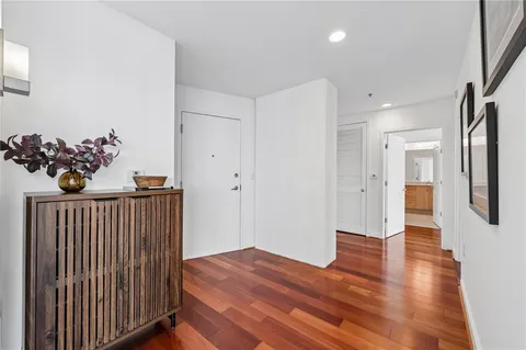 a view of a hallway with wooden floor