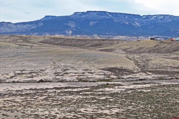 a view of ocean with mountain and trees