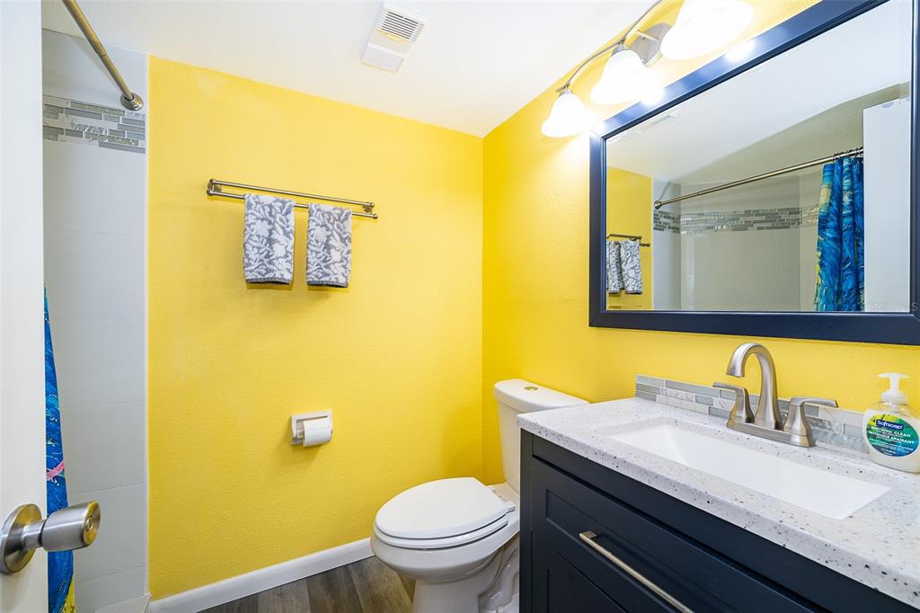 3916 Atrium Drive, Unit 4 Orlando, FL 32822 - Photo 19 of 71 a bathroom with a granite countertop toilet sink and mirror