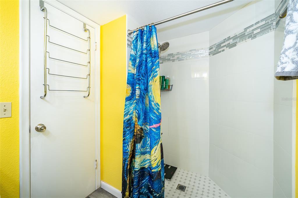 3916 Atrium Drive, Unit 4 Orlando, FL 32822 - Photo 20 of 71 a bathroom with a shower curtain and a window