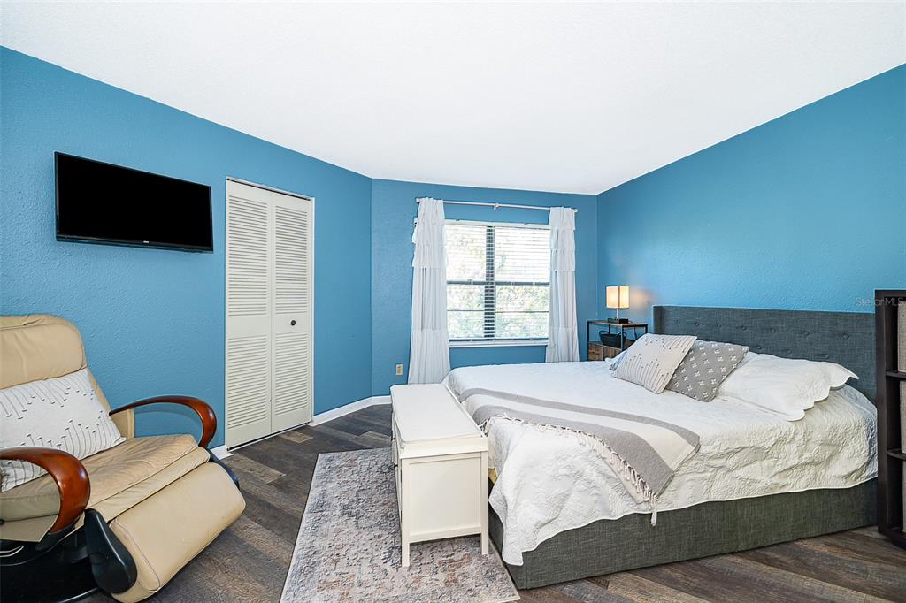 3916 Atrium Drive, Unit 4 Orlando, FL 32822 - Photo 23 of 71 a bedroom with a bed and a flat screen tv