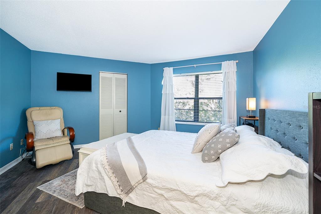 3916 Atrium Drive, Unit 4 Orlando, FL 32822 - Photo 24 of 71 a bedroom with a bed and a large window