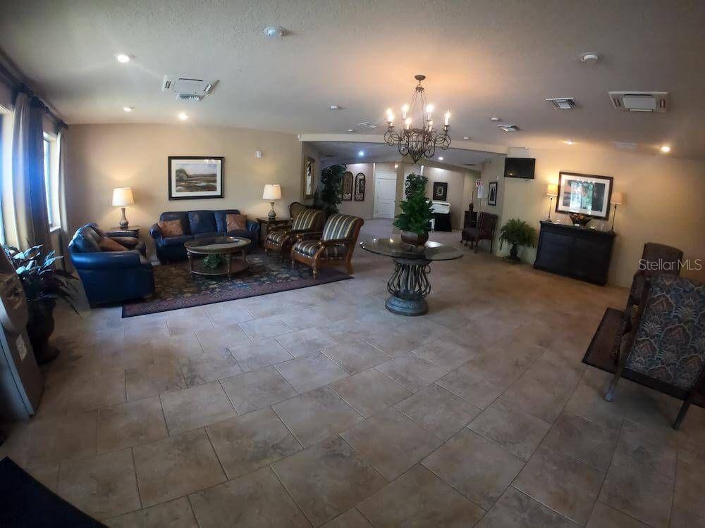 3916 Atrium Drive, Unit 4 Orlando, FL 32822 - Photo 49 of 71 a living room with furniture and a chandelier