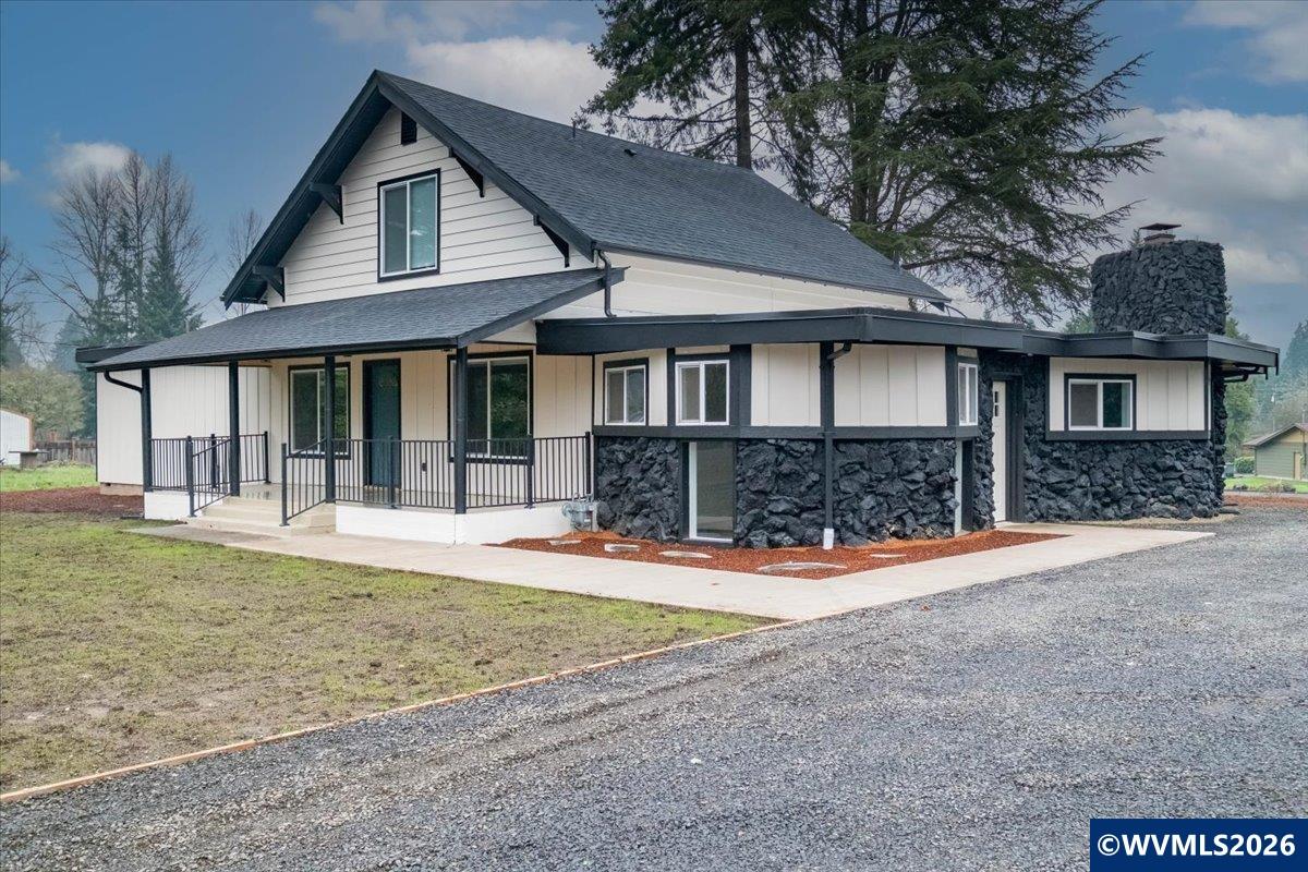 28411 Liberty Road Sweet Home, OR 97386 - Photo 6 of 50 a front view of a house with a yard and garage
