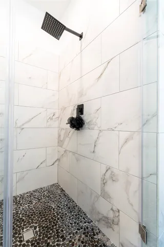 a view of a room with wooden floor and a bathroom